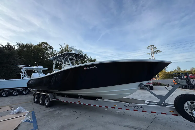 Slide: The Image of 2019 Yellowfin 34 Offshore boat on trailer, parked outdoors under a clear sky. - 8