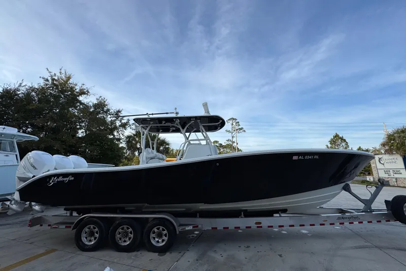 Slide: The Image of 2019 Yellowfin 34 Offshore boat on trailer, parked outdoors under a clear sky. - 9