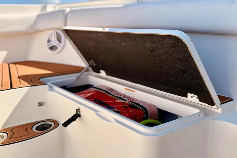 Slide: The Image of Open storage compartment on 2016 Sailfish 290 CC boat, showing interior contents. - 12