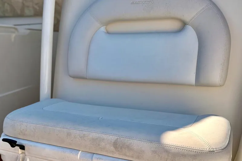 Slide: The Image of 2016 Sailfish 290 CC boat seat, white upholstery, close-up view. - 13