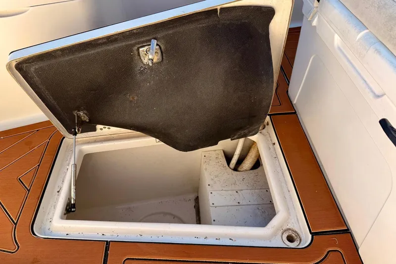 Slide: The Image of Open storage compartment on 2016 Sailfish 290 CC boat deck. - 14