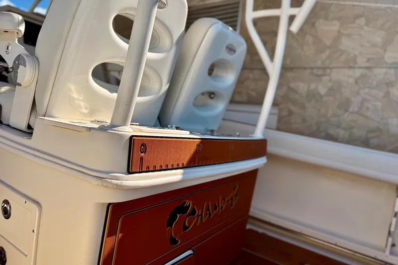 Slide: The Image of 2016 Sailfish 290 CC boat interior with white seating and measuring board. - 26