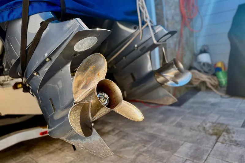 Slide: The Image of Close-up of 2016 Sailfish 290 CC boat propellers in a garage setting. - 8