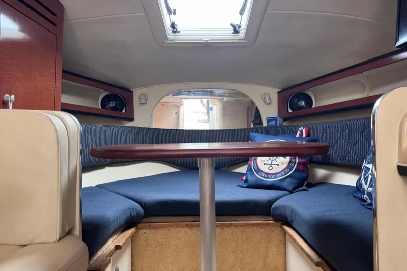 Slide: The Image of 2005 Sea Ray 280 Sundancer cabin interior with seating and table. - 12