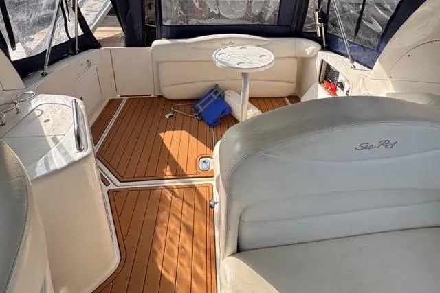 Slide: The Image of 2005 Sea Ray 280 Sundancer interior with teak flooring and white seating. - 17