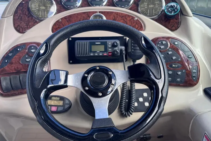 Slide: The Image of Steering wheel and dashboard of 2005 Sea Ray 280 Sundancer boat with control panels. - 21