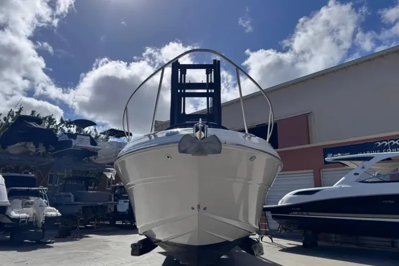 Slide: The Image of 2005 Sea Ray 280 Sundancer boat in a marina under a cloudy sky. - 4