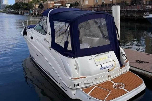 Slide: The Image of 2005 Sea Ray 280 Sundancer docked, featuring blue canopy and Miami Beach registration. - 6