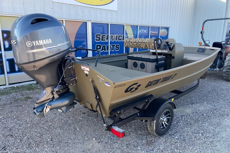 Slide: The Image of 2026 G3 Gator Tough 17 CCJ boat with Yamaha motor, parked on gravel. - 4