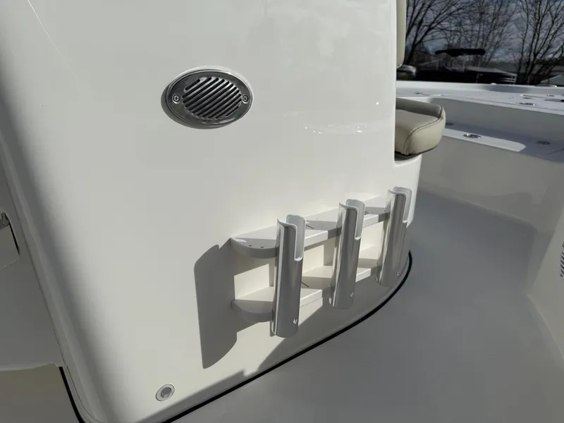 Slide: The Image of Key West 210 Bay Reef 2025 boat interior with rod holders and speaker. - 13