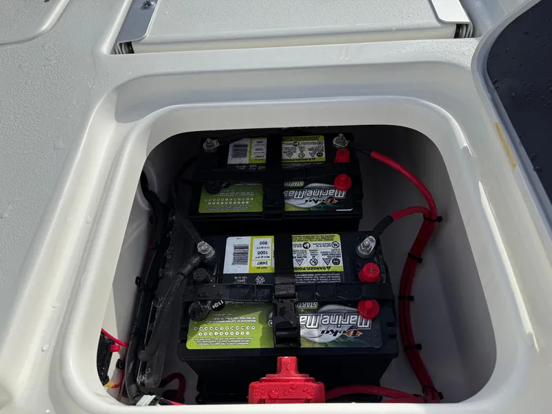 Slide: The Image of 2025 Key West 210 Bay Reef boat battery compartment with dual marine batteries. - 18