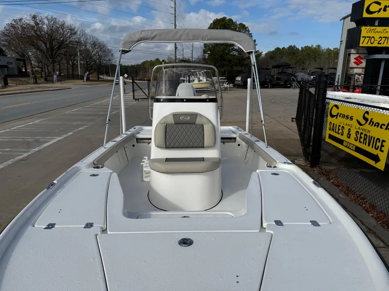Slide: The Image of 2025 Key West 210 Bay Reef boat with canopy, parked near sales and service office. - 20