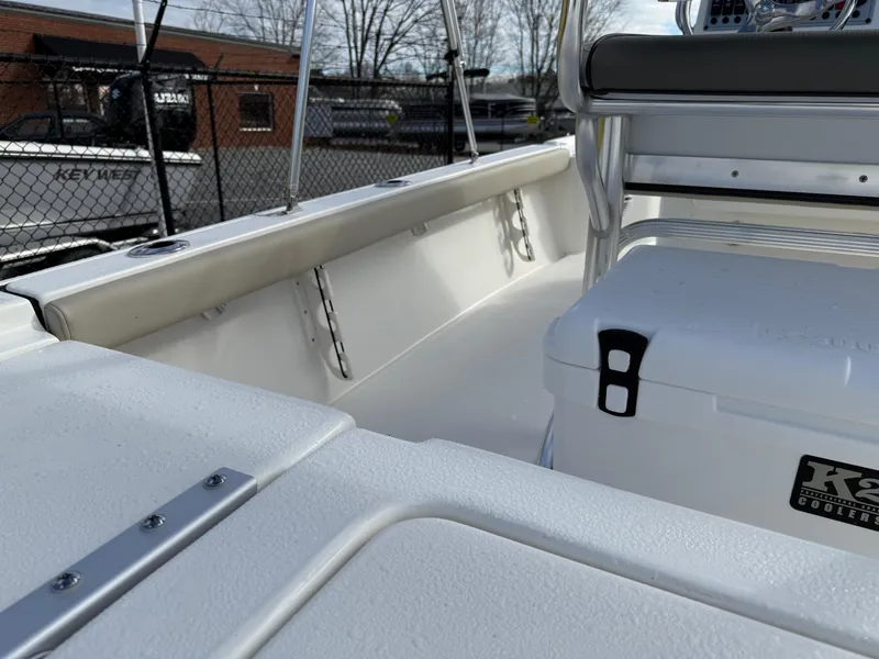 Slide: The Image of 2025 Key West 210 Bay Reef boat interior with seating and storage. - 24