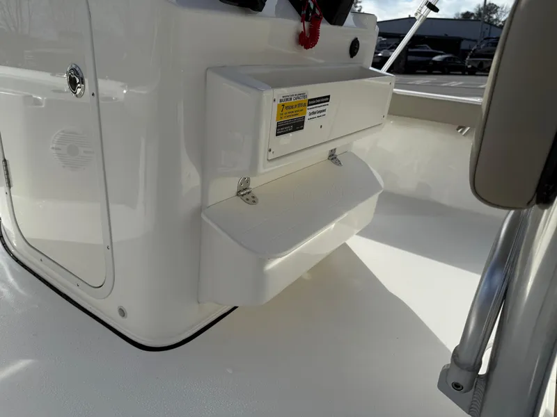 Slide: The Image of 2025 Key West 210 Bay Reef boat interior, featuring storage compartment and seating area. - 25