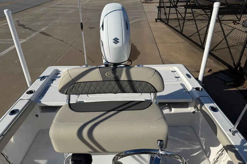 Slide: The Image of 2026 Key West 210 Bay Reef boat with Suzuki outboard motor, docked on concrete. - 33