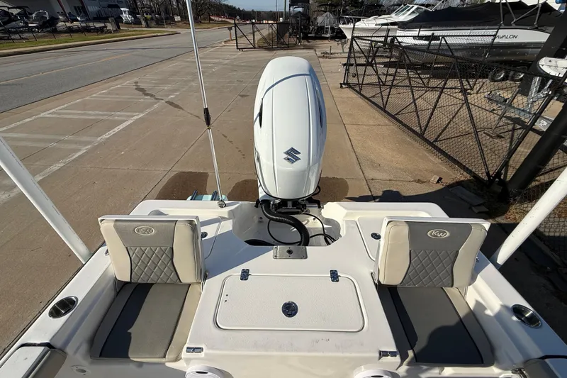 Slide: The Image of 2026 Key West 210 Bay Reef boat with Suzuki outboard motor, docked on concrete pavement. - 37