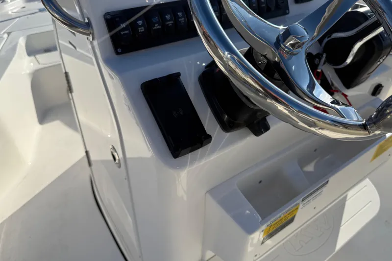 Slide: The Image of Steering console of 2026 Key West 210 Bay Reef boat with controls and chrome wheel. - 38
