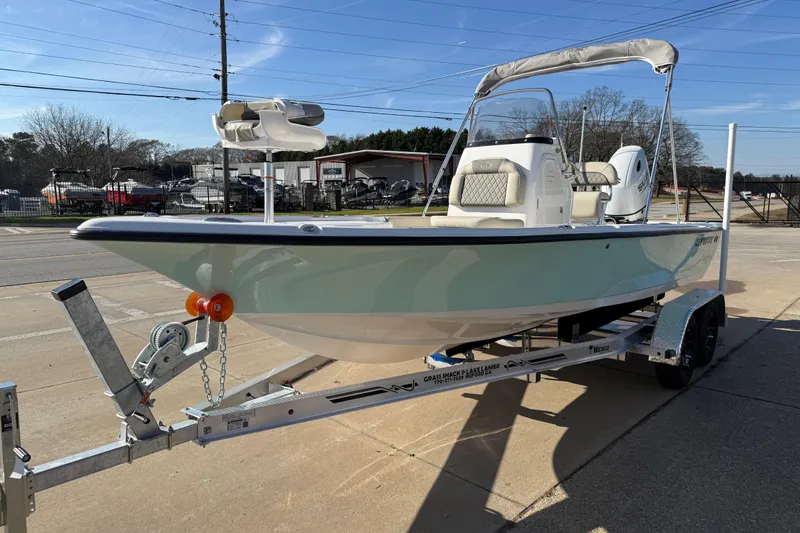 Slide: The Image of 2026 Key West 210 Bay Reef boat on trailer, parked outdoors under clear sky. - 7
