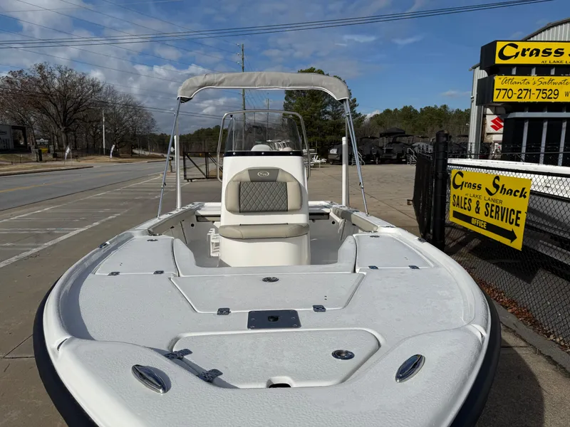 Slide: The Image of 2025 Key West 210 Bay Reef boat at dealership, sunny day, sales sign visible. - 8