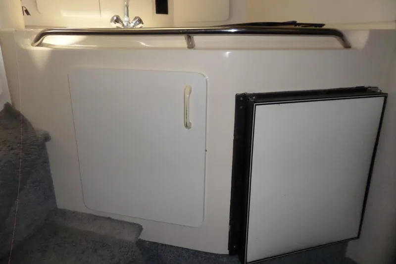 Slide: The Image of 1994 Searay 300 Weekender interior with sink and storage cabinet. - 13
