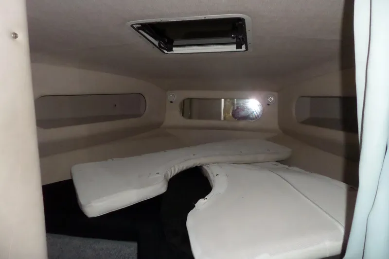 Slide: The Image of 1994 Searay 300 Weekender cabin interior with cushions and portholes. - 16
