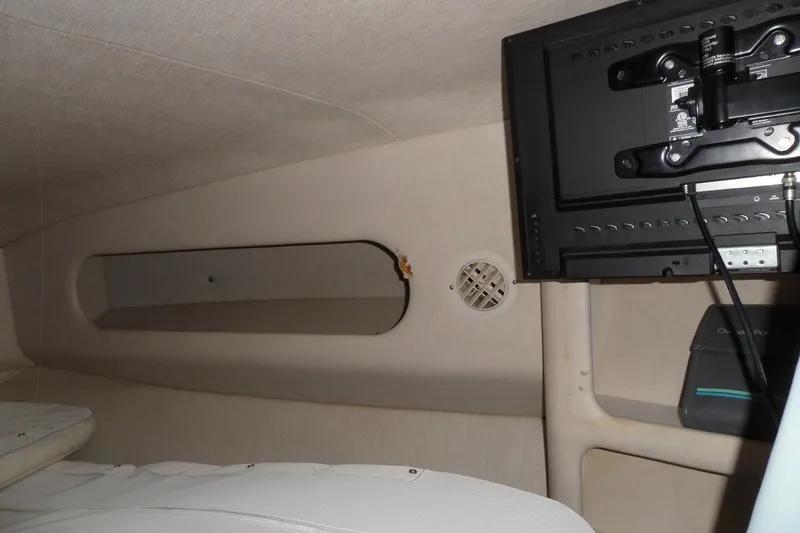 Slide: The Image of Interior of a 1994 Searay 300 Weekender boat with mounted TV and speaker. - 18