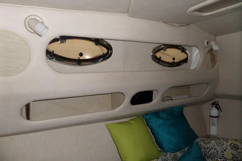 Slide: The Image of Interior cabin of a 1994 Searay 300 Weekender with portholes and colorful cushions. - 19