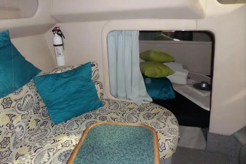 Slide: The Image of 1994 Searay 300 Weekender cabin interior with patterned seating and colorful cushions. - 24