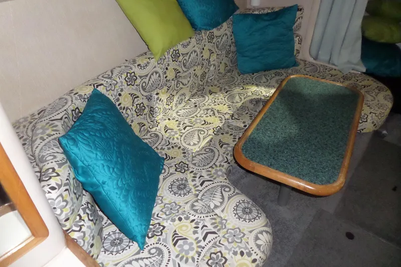 Slide: The Image of Interior of 1994 Searay 300 Weekender with patterned seating and colorful cushions. - 25