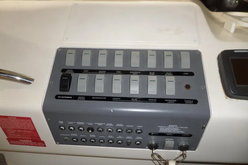 Slide: The Image of Control panel of a 1994 Searay 300 Weekender boat with various switches and labels. - 29