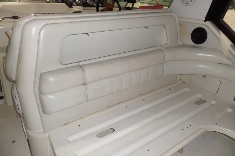 Slide: The Image of 1994 Searay 300 Weekender boat interior with white seating and dashboard. - 34