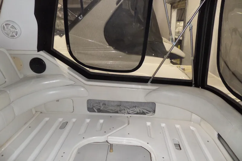 Slide: The Image of 1994 Searay 300 Weekender boat interior with white seating and window view. - 35