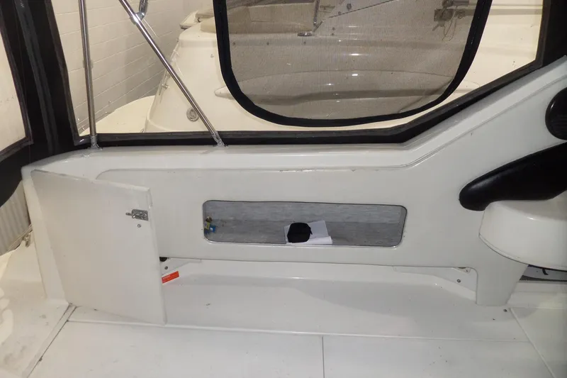Slide: The Image of Interior view of a 1994 Searay 300 Weekender boat, featuring a storage compartment. - 37
