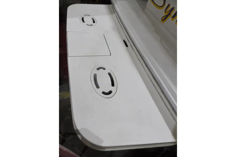 Slide: The Image of 1994 Searay 300 Weekender boat deck with cup holders and storage compartment. - 42