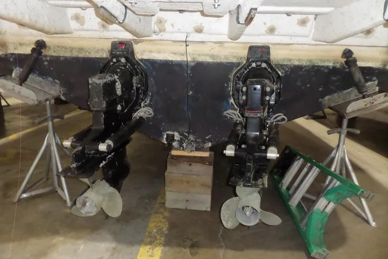 Slide: The Image of 1994 Searay 300 Weekender boat with dual propellers on stands in a garage. - 46