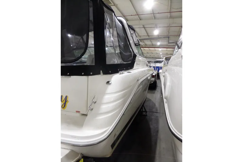 Slide: The Image of 1994 Searay 300 Weekender boat in indoor storage, rear view. - 8