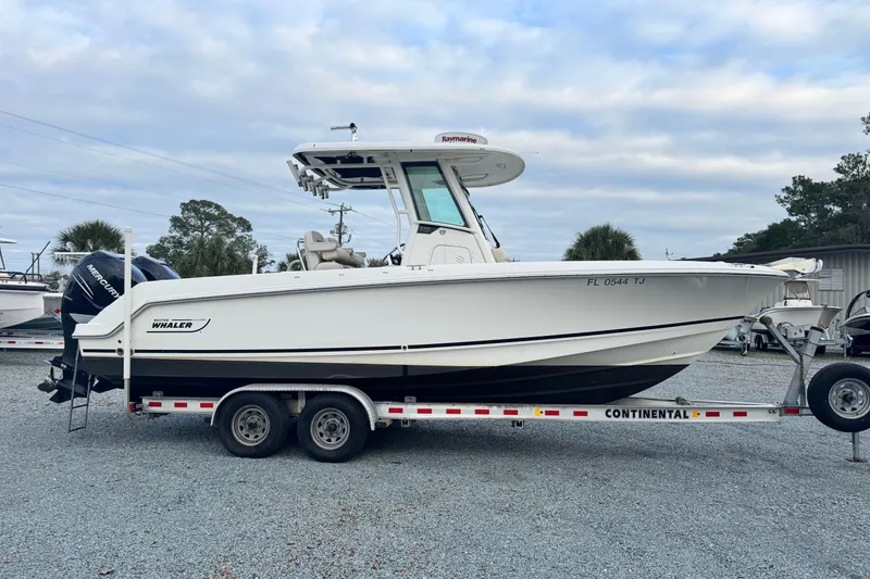 Slide: The Image of 2018 Boston Whaler 250 Outrage boat on trailer, side view, outdoors. - 4