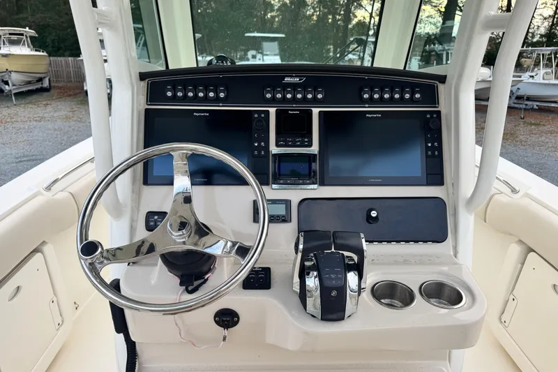 Slide: The Image of 2018 Boston Whaler 250 Outrage helm with dual screens and controls. - 5