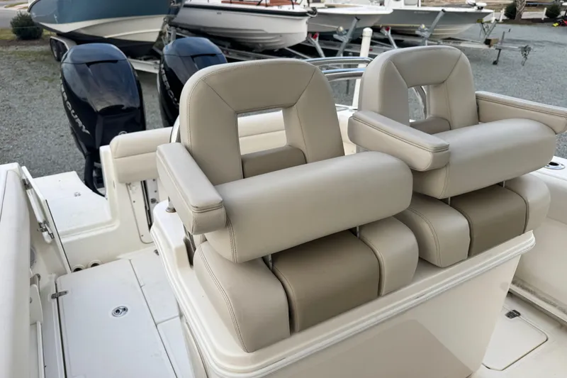 Slide: The Image of 2018 Boston Whaler 250 Outrage boat seats with dual Mercury engines in the background. - 6