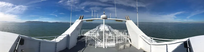 Slide: The Image of High-speed passenger ferry cruising on open water under a clear blue sky. - 5