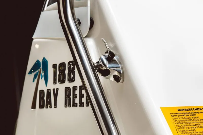 Slide: The Image of 2026 Key West 188 Bay Reef boat storage compartment with open lid, showcasing interior space. - 11