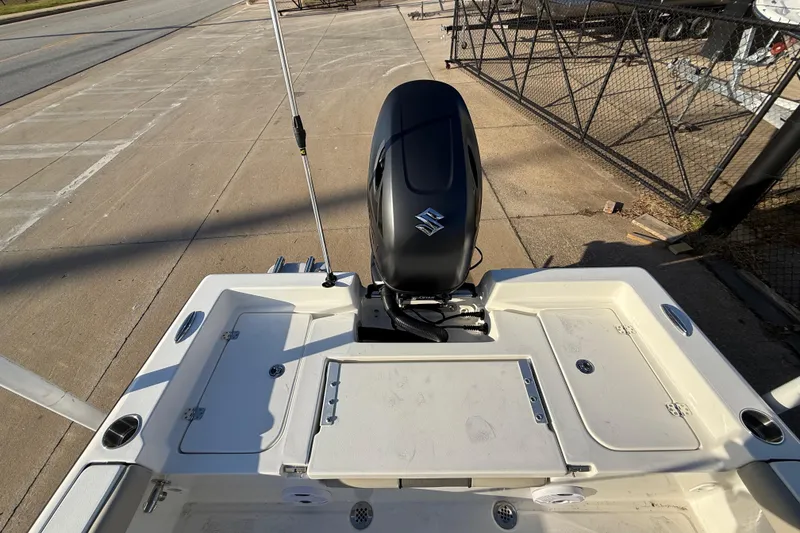 Slide: The Image of 2026 Key West 188 Bay Reef boat with Suzuki outboard motor, docked on concrete pavement. - 15