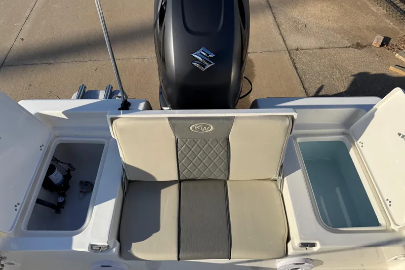 Slide: The Image of 2026 Key West 188 Bay Reef boat interior with seating and storage compartments. - 16