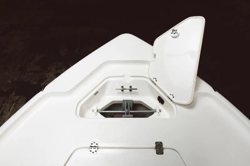 Slide: The Image of 2026 Key West 188 Bay Reef boat with outboard motor, parked outdoors. - 4