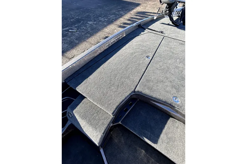 Slide: The Image of 2026 Skeeter ZXE21 boat deck with gray carpet and storage compartments. - 12