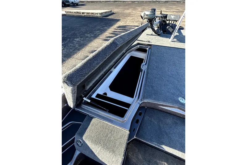 Slide: The Image of 2026 Skeeter ZXE21 boat with open storage compartment on deck. - 13