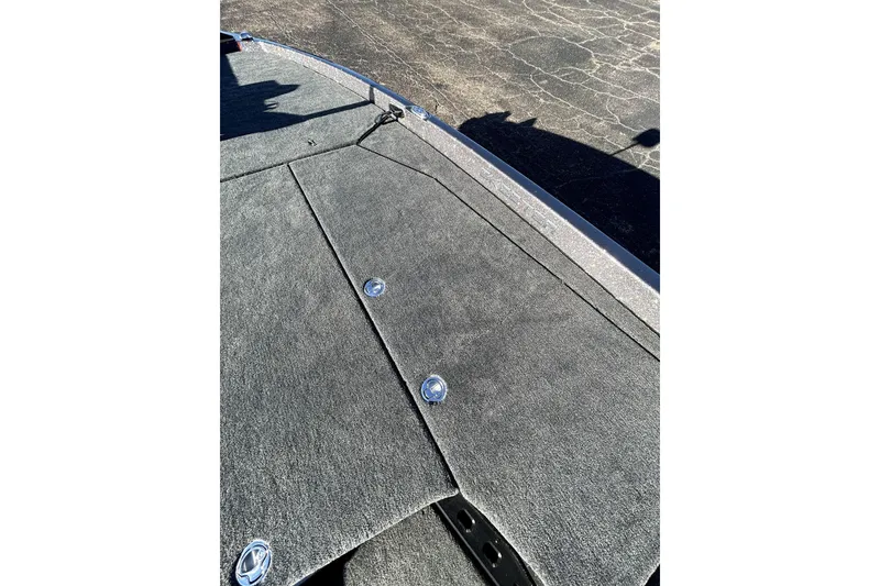 Slide: The Image of 2026 Skeeter ZXE21 boat deck with carpeted surface and storage compartments. - 16