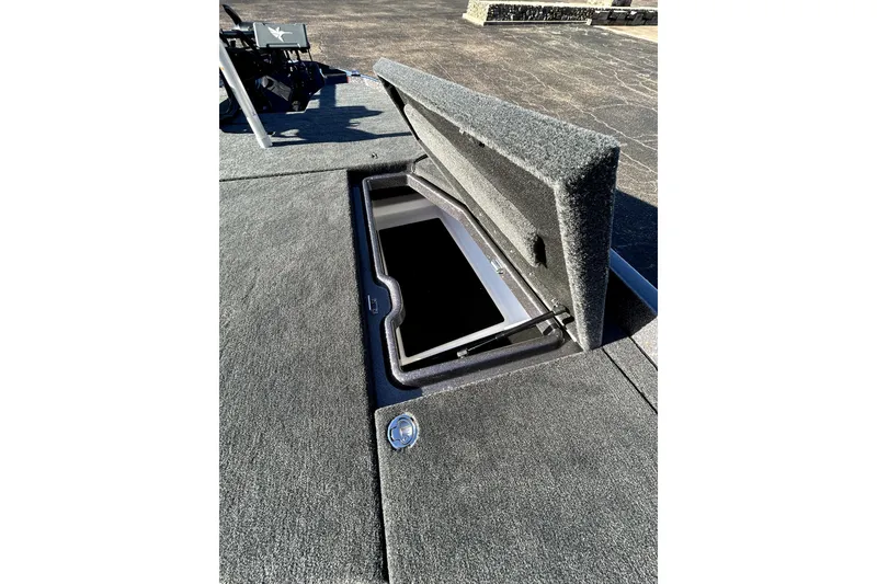 Slide: The Image of Open storage compartment on 2026 Skeeter ZXE21 boat deck. - 17