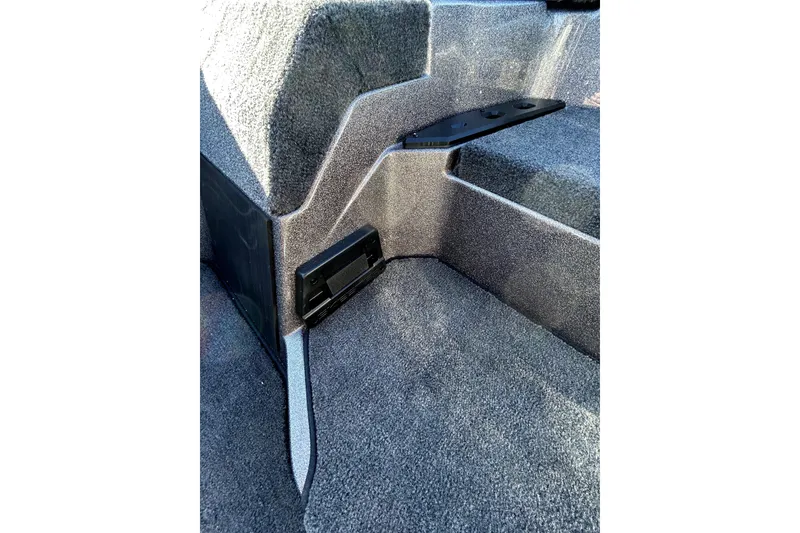 Slide: The Image of Interior view of 2026 Skeeter ZXE21 boat, featuring carpeted steps and storage compartment. - 21