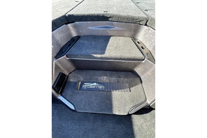 Slide: The Image of Interior view of 2026 Skeeter ZXE21 boat with carpeted steps and logo. - 22